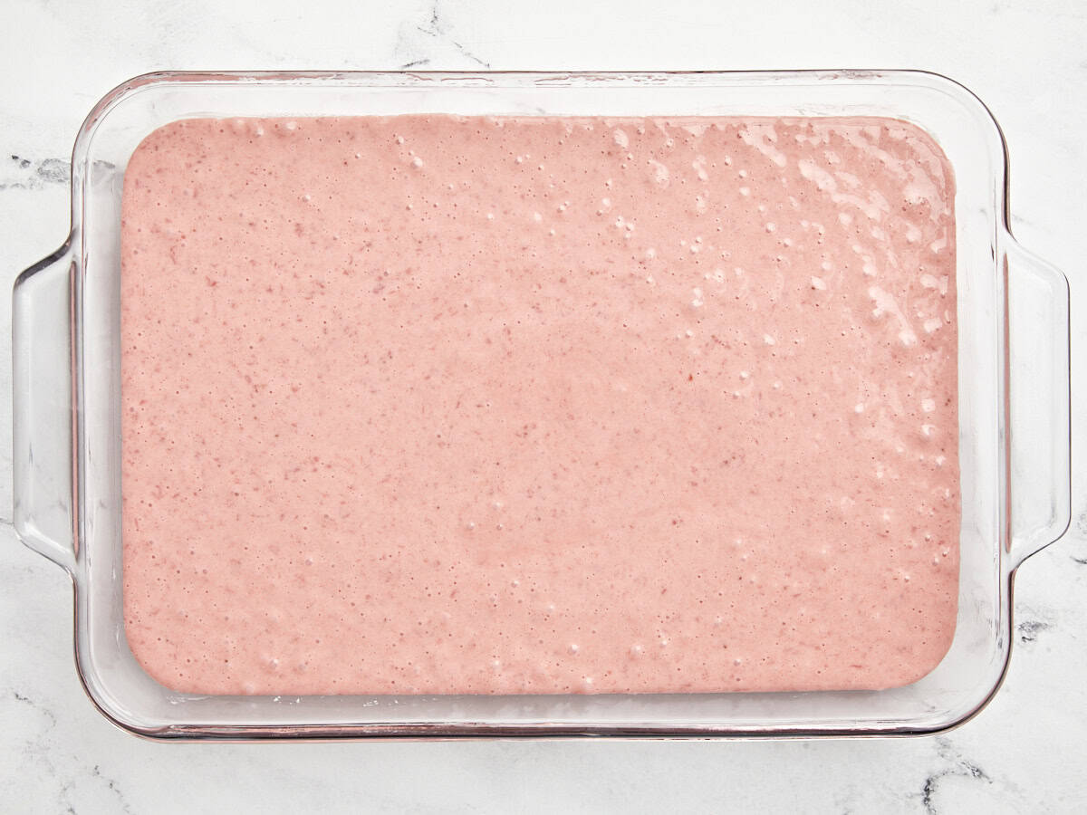 Cake batter added to greased baking dish.