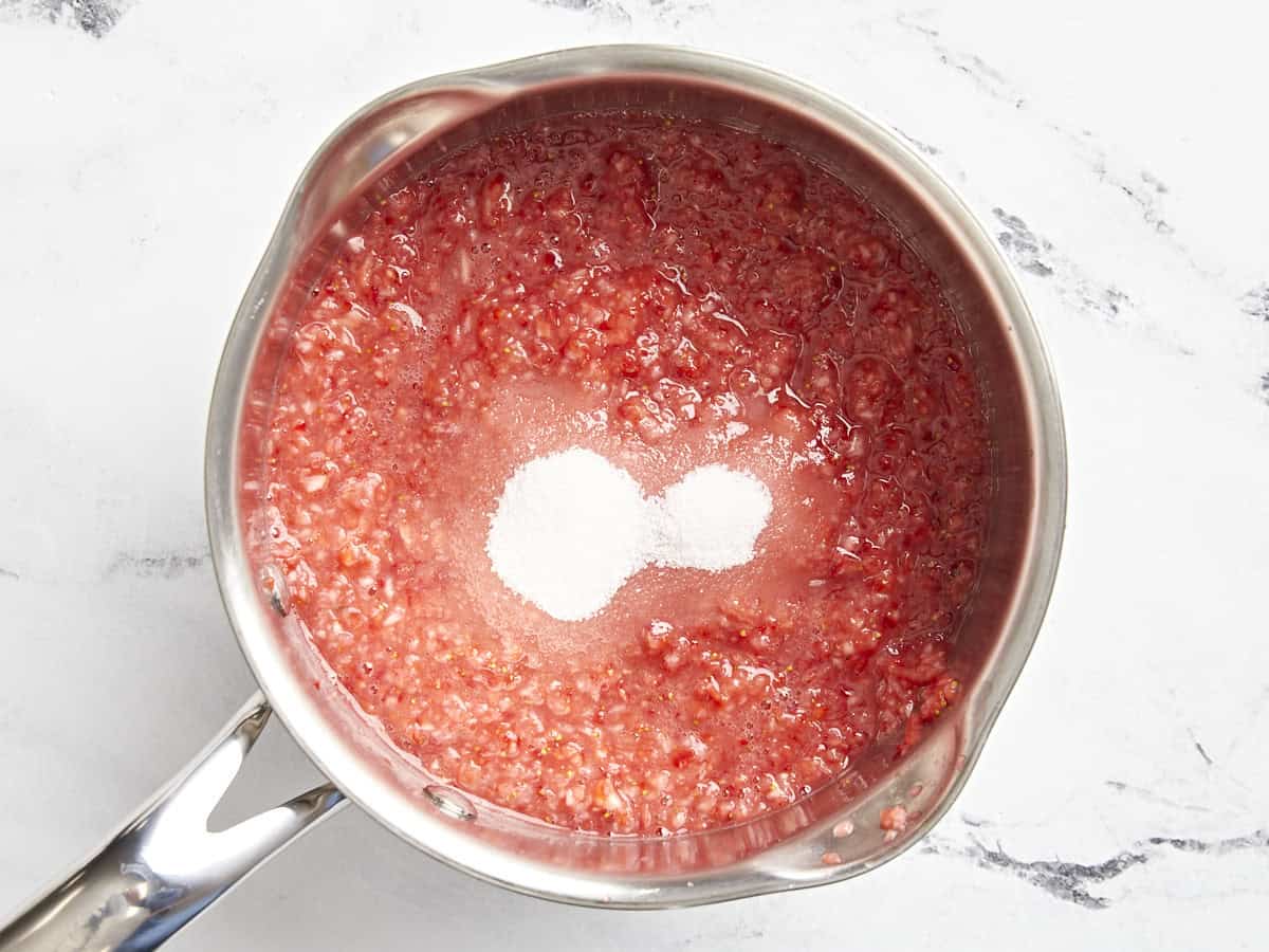 Strawberry puree and sugar added to a saucepan.