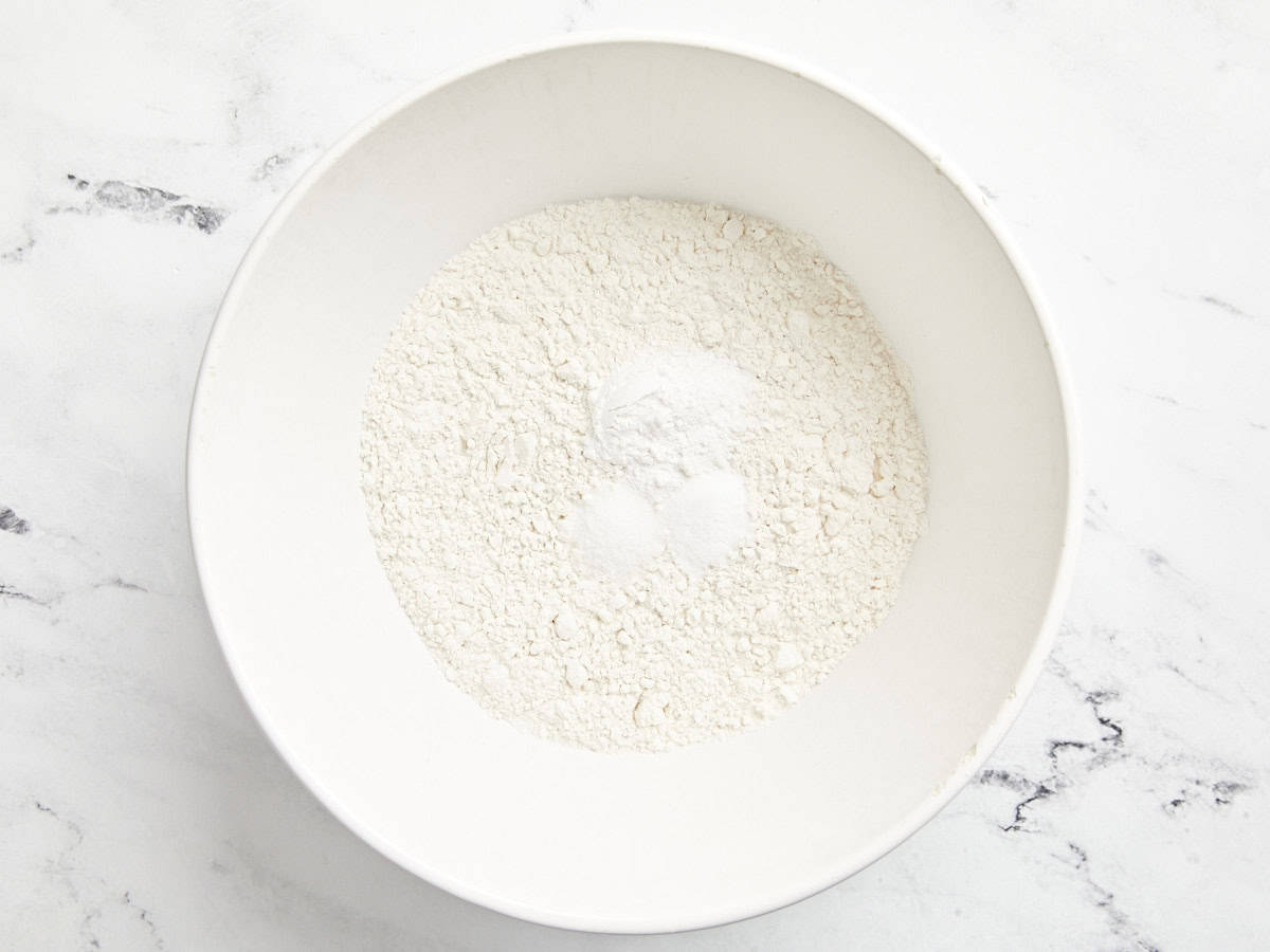 Cake dry ingredients added to a bowl.