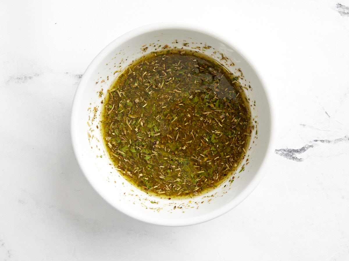 dressing for barley salad in a white bowl.