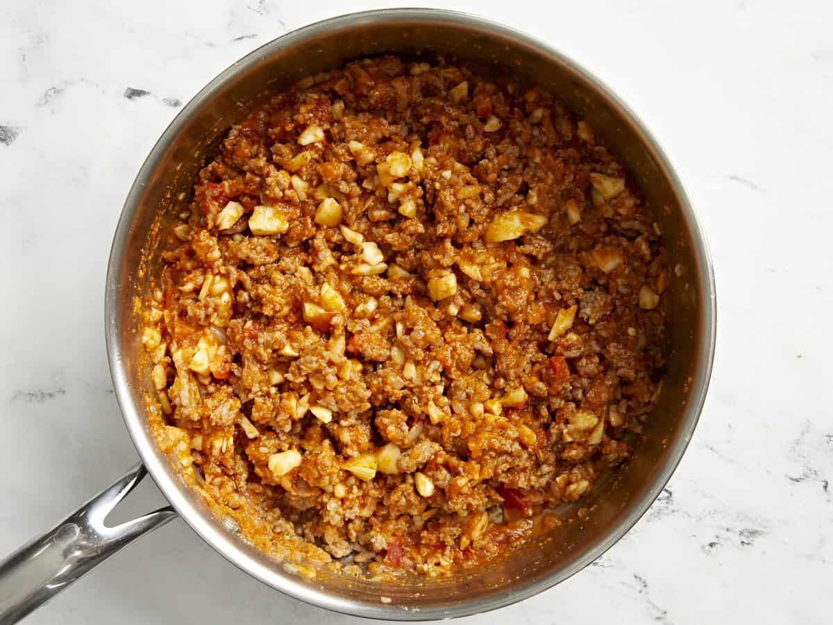 Italian sausage mixture for zucchini boats in a saucepan.