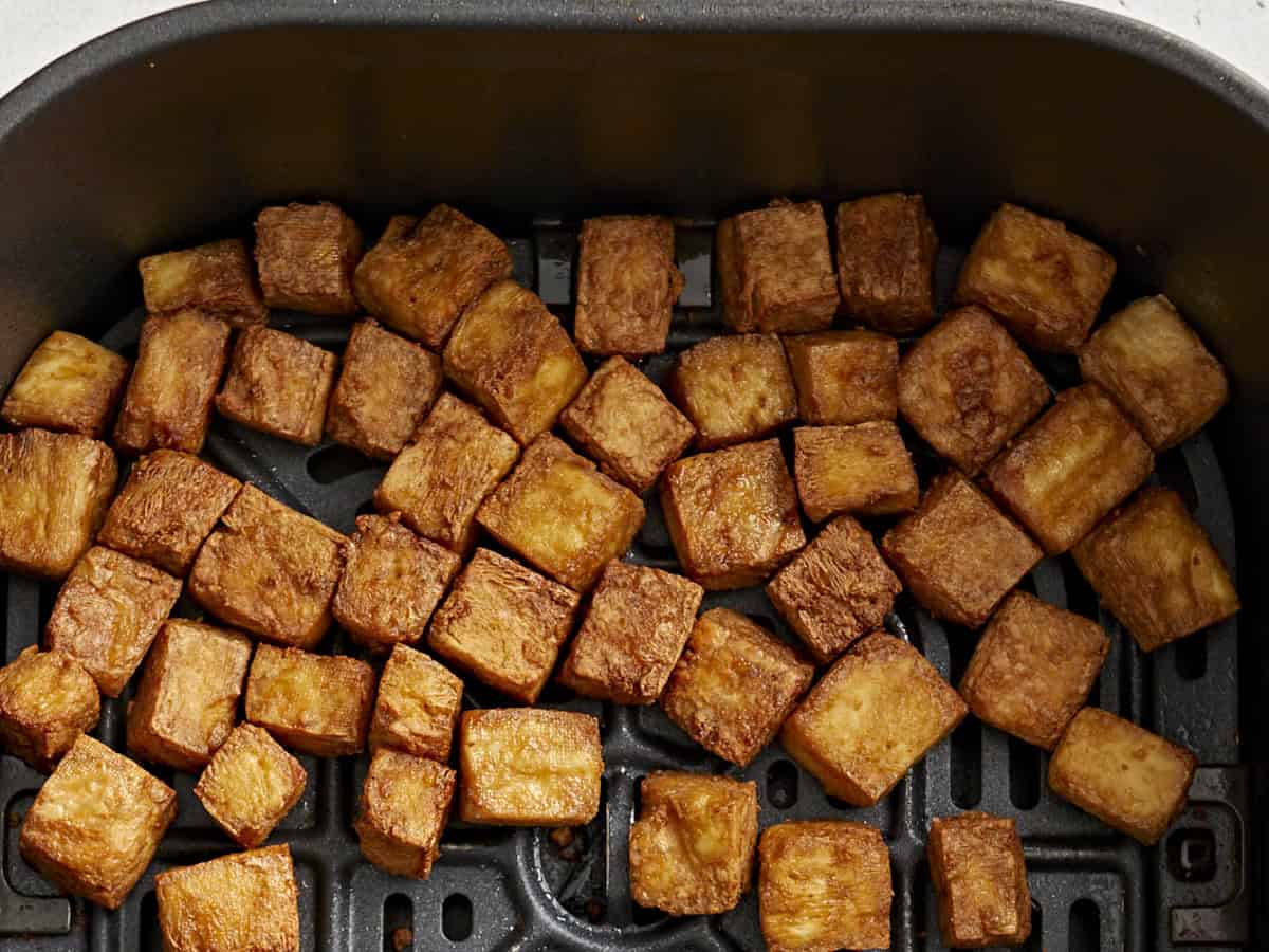 overhead view of air fryer tofu in an air fryer basket.