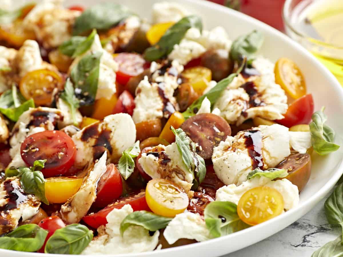 caprese salad on a white serving plate.