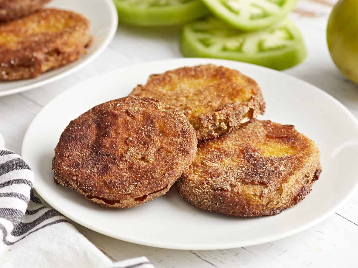 3 fried green tomatoes on a white plate.