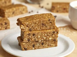 3 stacked granola bars on a white plate.