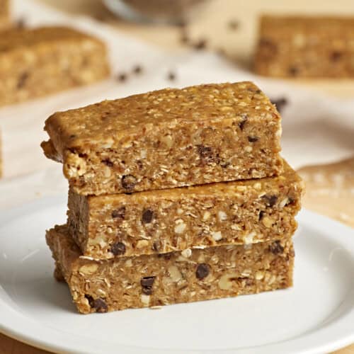 3 stacked granola bars on a white plate.