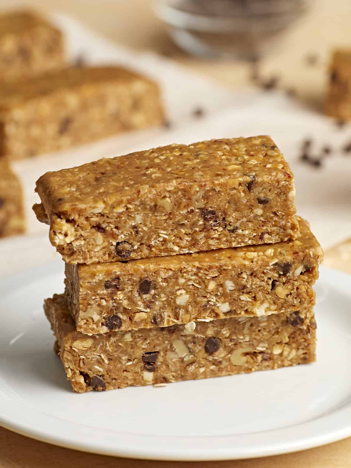 3 stacked granola bars on a white plate.