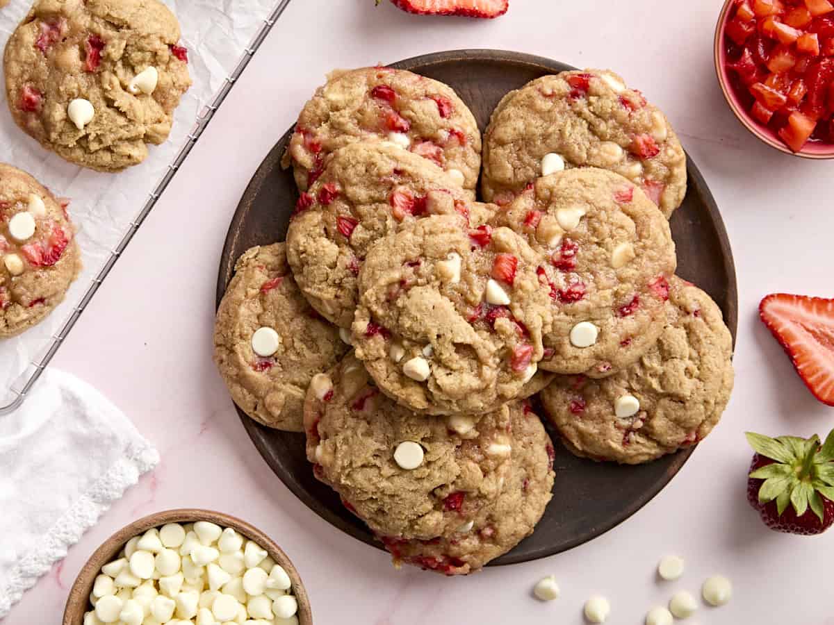 overhead view of strawberry cookies stacked on a black plate.