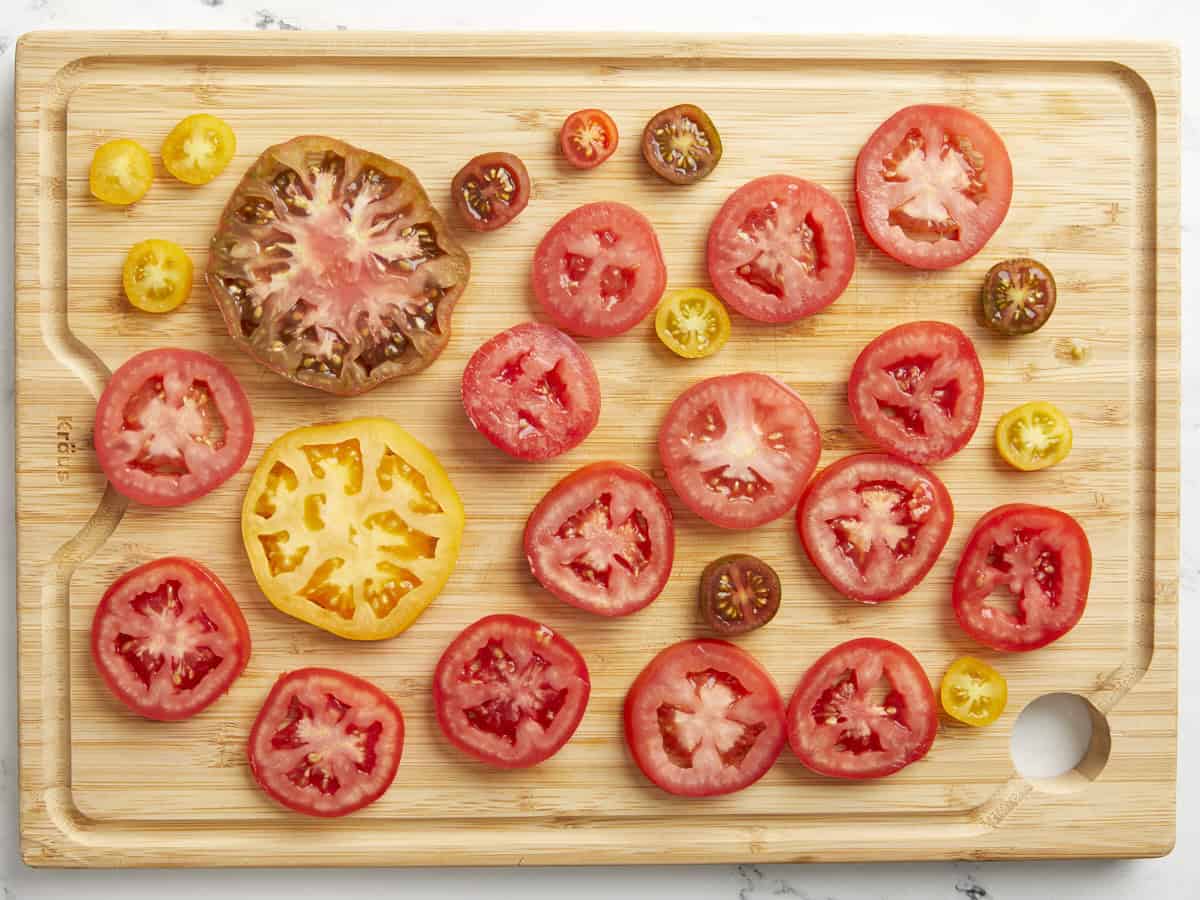 Sliced tomatoes on a chopping board.