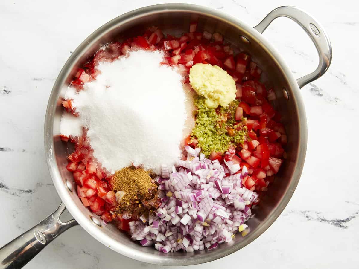 Ingredients for tomato relish in a pan.