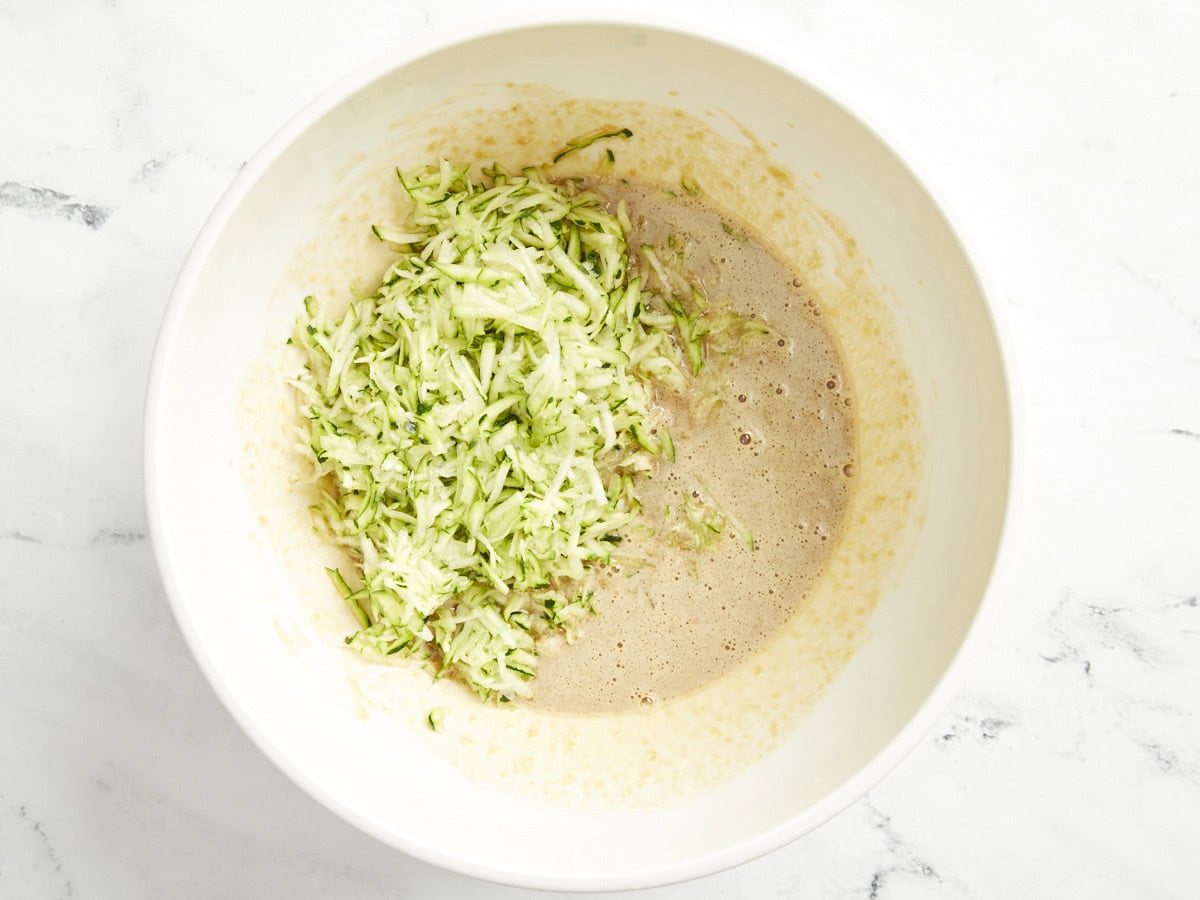 Grated zucchini added to wet ingredients.