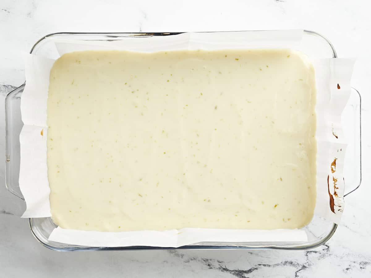 Cooked key lime pie bars in a baking dish, ready to be sliced.