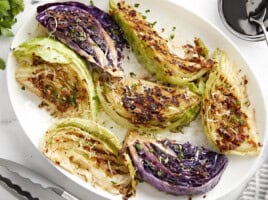 Close-up of grilled cabbage wedges on a plate.