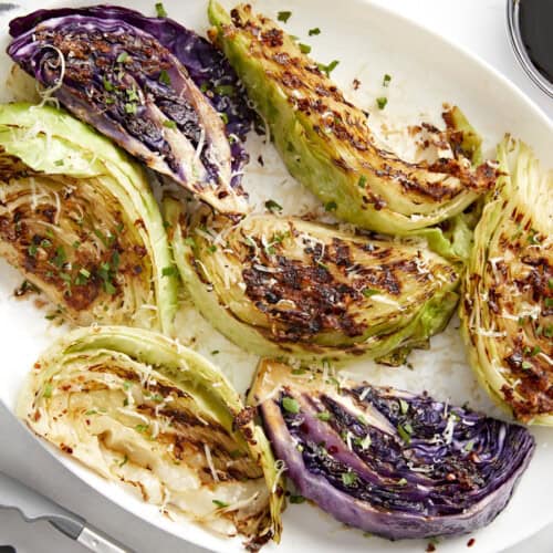 Close-up of grilled cabbage wedges on a plate.