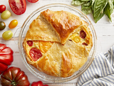 Overhead shot of a delicious tomato pie on a table.