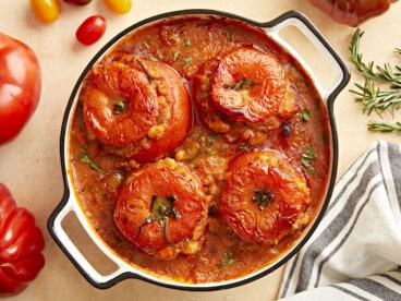 Overhead view of stuffed tomatoes with white beans.