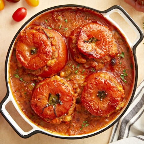 Overhead view of stuffed tomatoes with white beans.