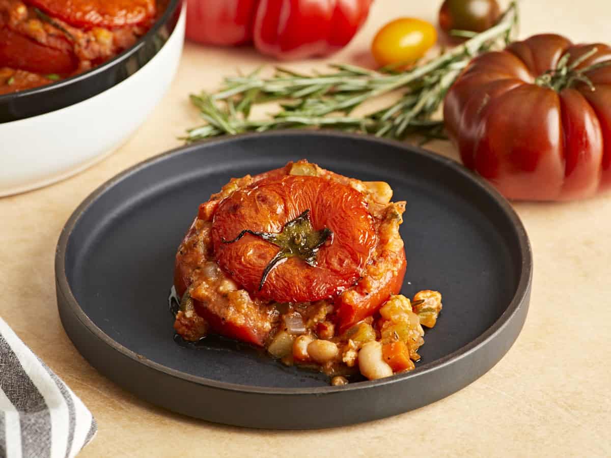 A tuscan white bean stuffed tomato on a plate.