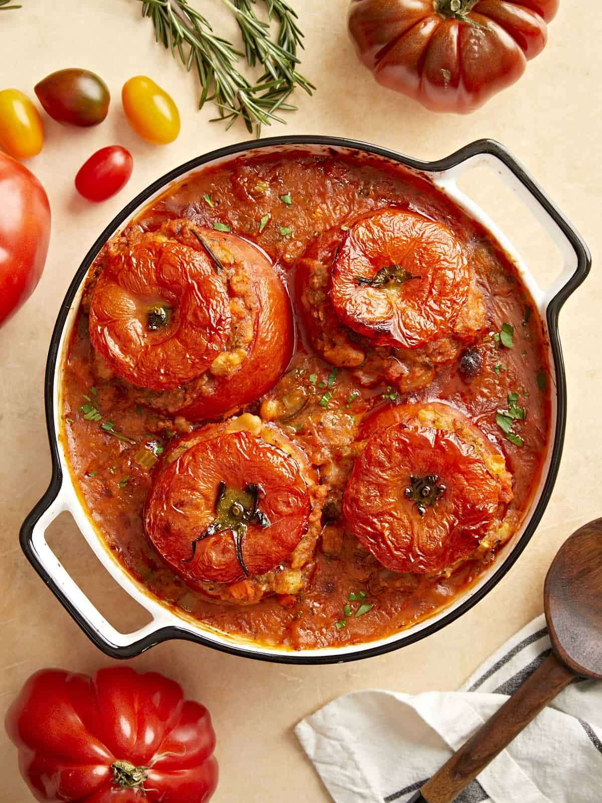 Tuscan white bean stuffed tomatoes in a baking dish.