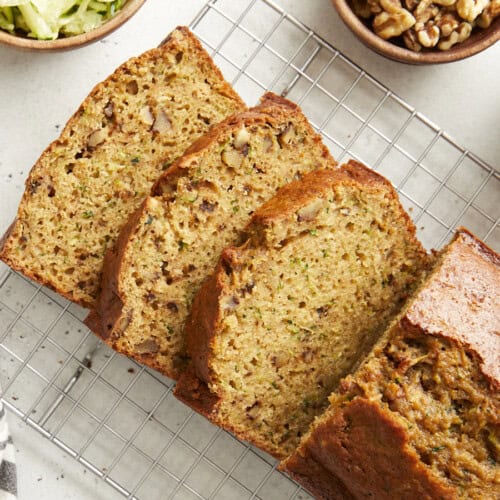 Overhead view of zucchini bread sliced on a cooling rack.