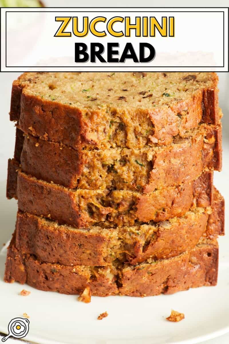 Close up view of slices of zucchini bread stacked on a plate.