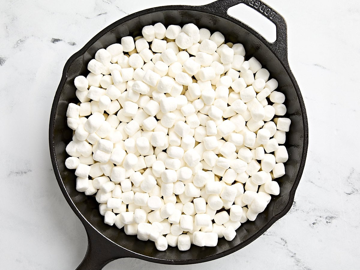 Chocolate chips and mini marshmallows in a skillet for s'mores dip