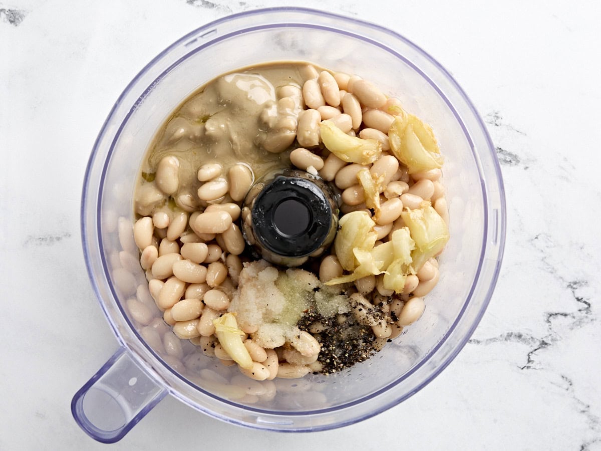 Ingredients for white bean hummus added to a food processor