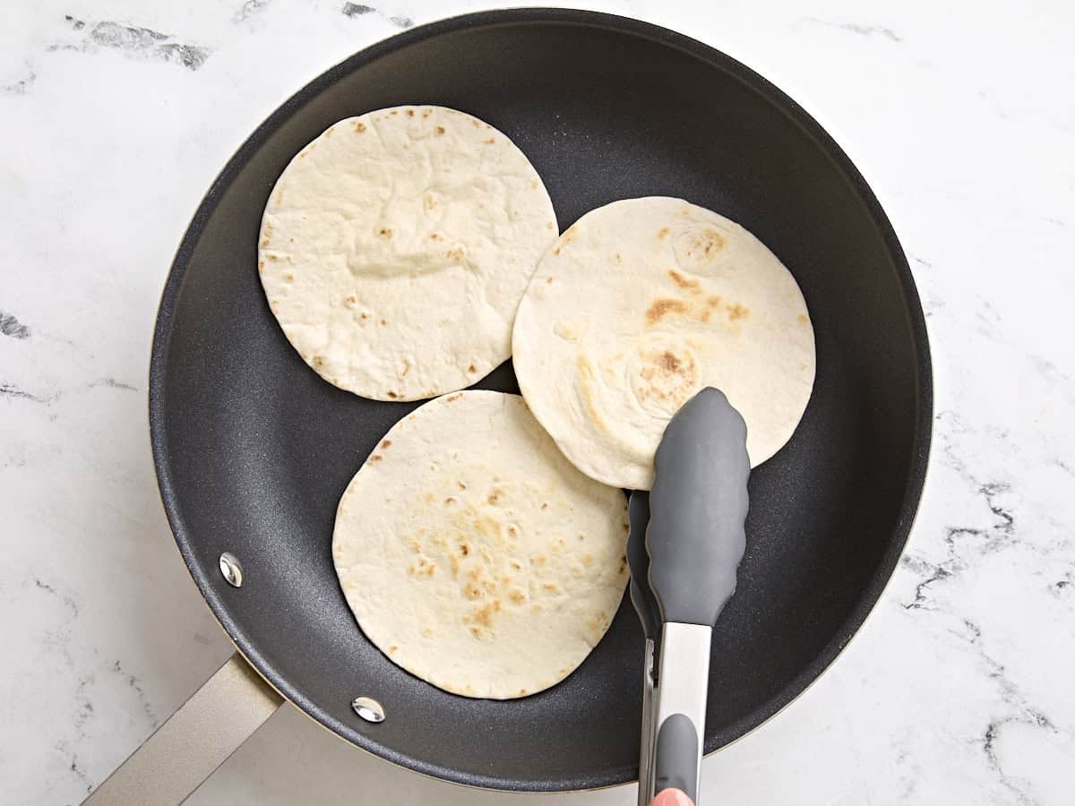 Tortillas warming in a skillet