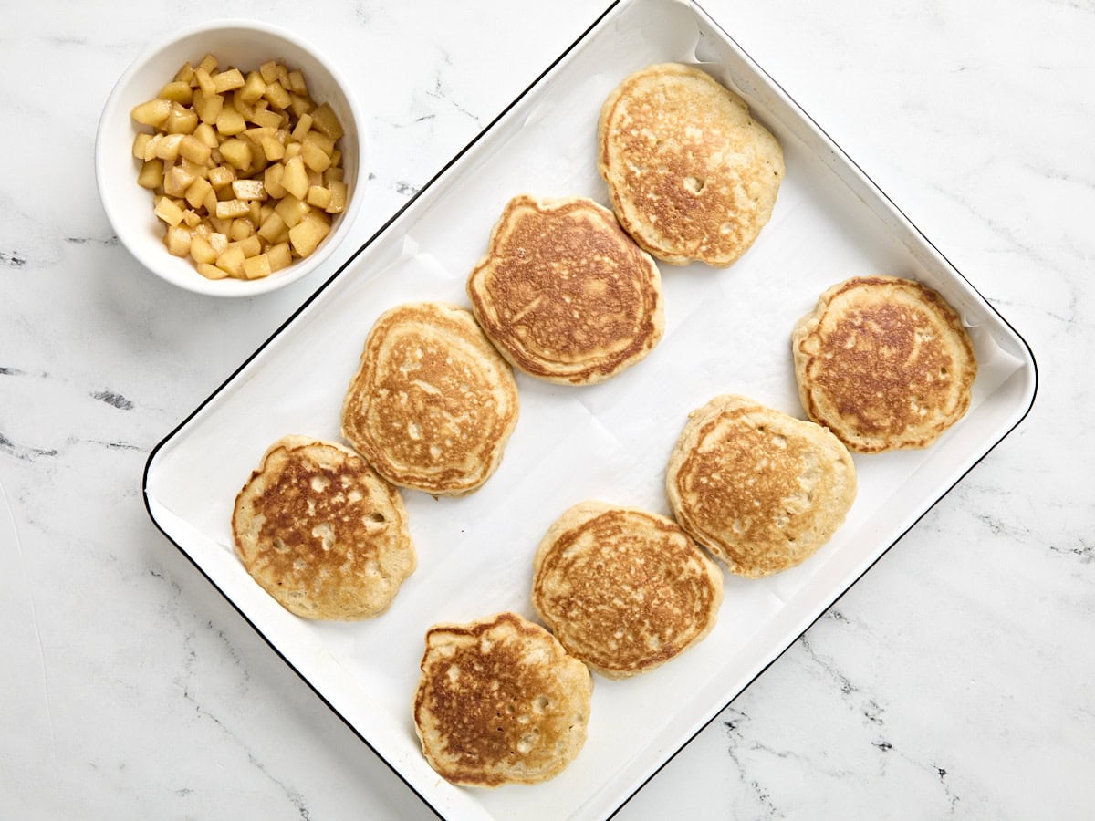 Pancakes resting on baking sheet.