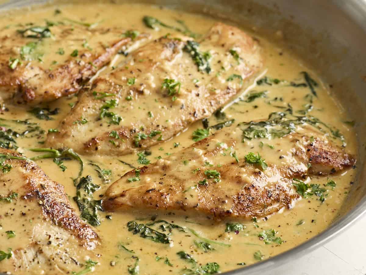 Side close up view of creamy dijon chicken in a skillet.