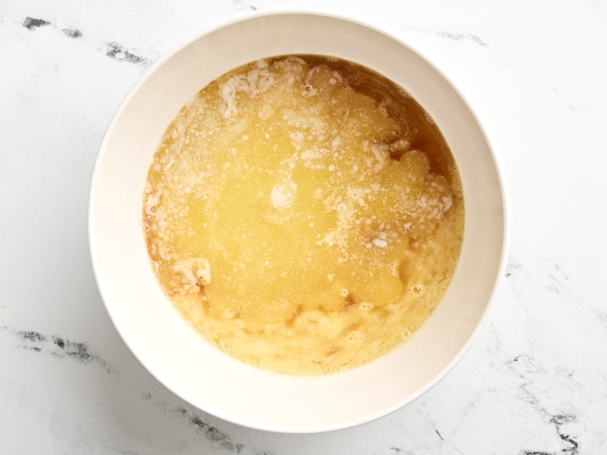 Wet ingredients for butter tarts in a mixing bowl.