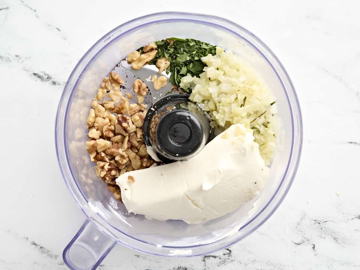 Cooked onions, with chopped walnuts, cream cheese, and parsley in a food processor.