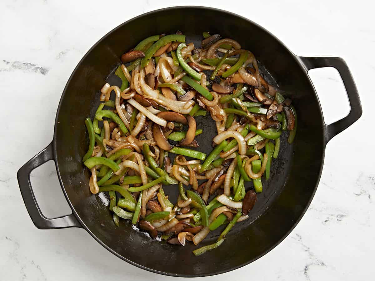 Peppers and Onions added to skillet