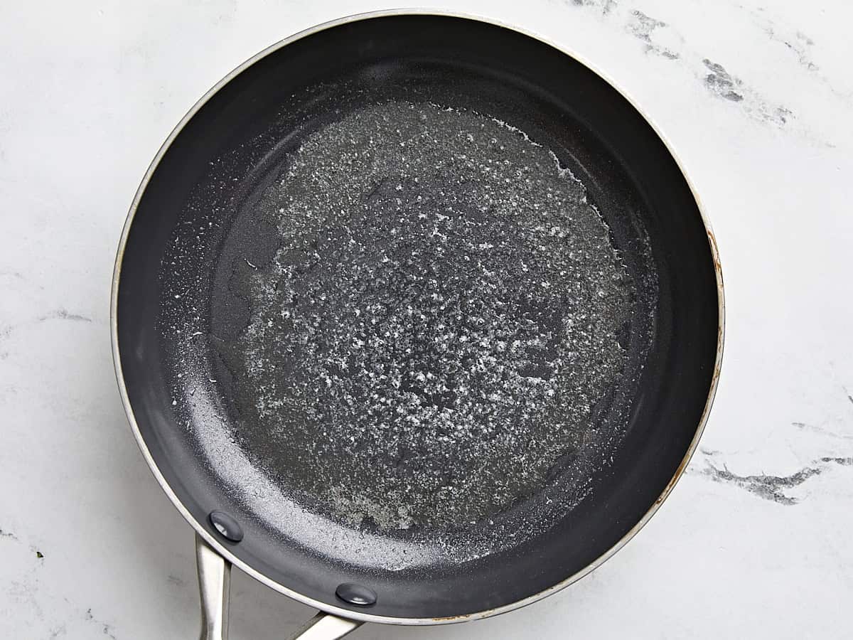 Melted butter in a non-stick frying pan.