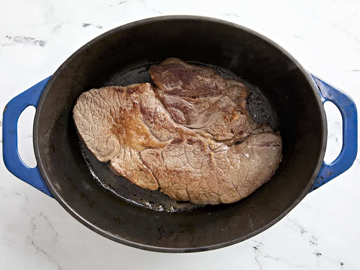 Pot roast browning in a dutch oven.