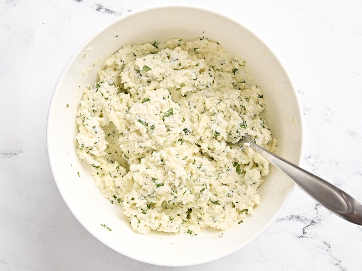 Stuffed shells cheese mixture combined in a bowl.