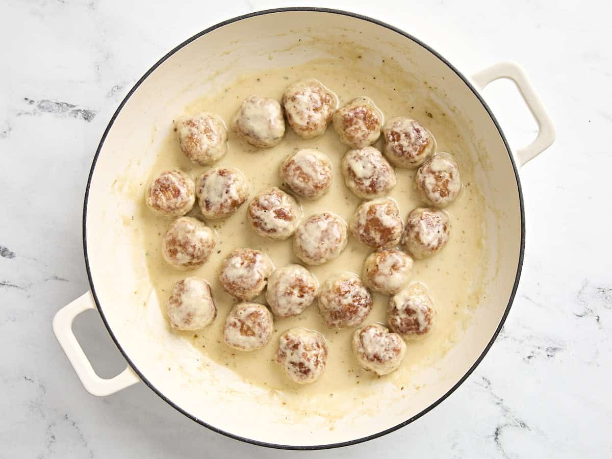 chicken meatballs added back to skillet in cream sauce.