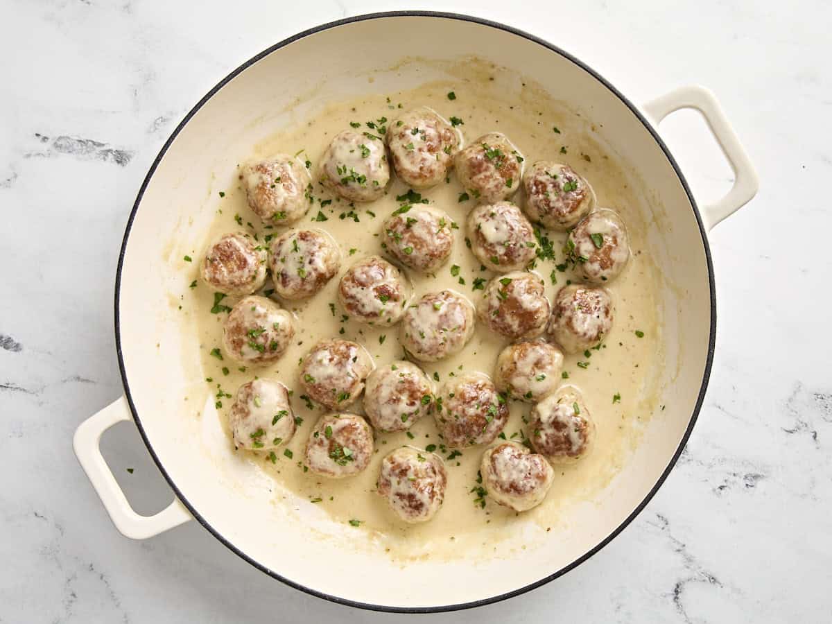 Finished chicken meatballs with cream sauce in large skillet