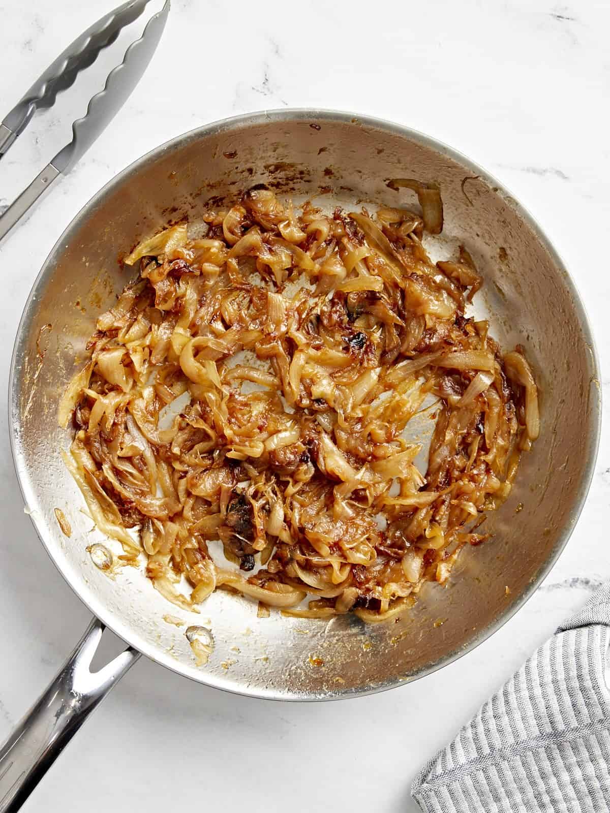 Overhead view of caramelized onions in a pan