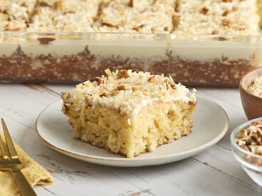 Side view of a fluffy cake with icing on a plate.