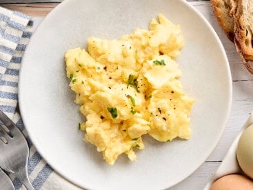 Overhead view of a plate of scrambled eggs.