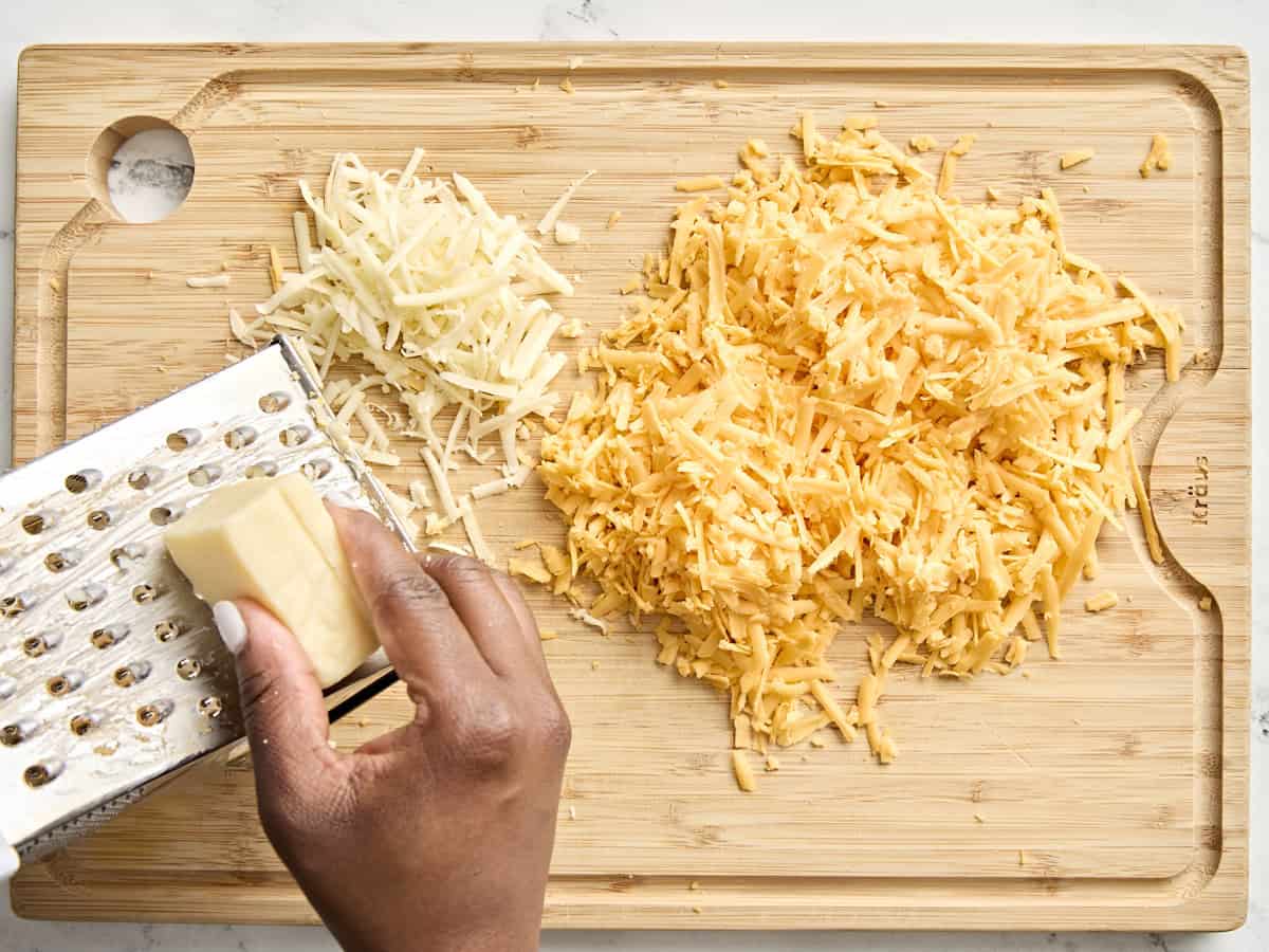 Blocks of cheese being shredded.