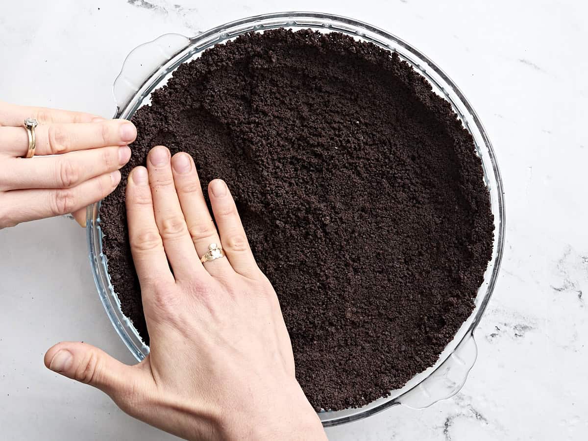 Oreo crust in a pie dish.