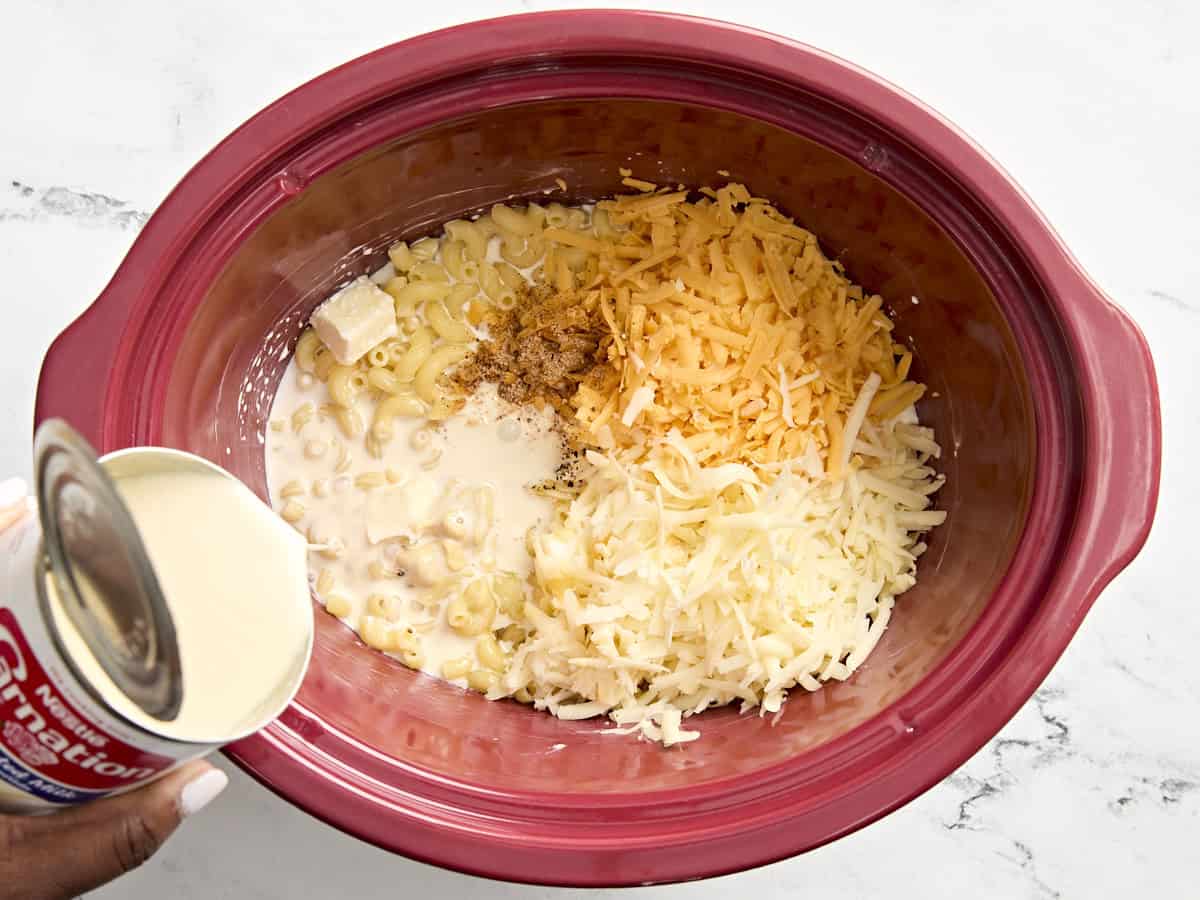 Mac and cheese ingredients added to slow cooker.