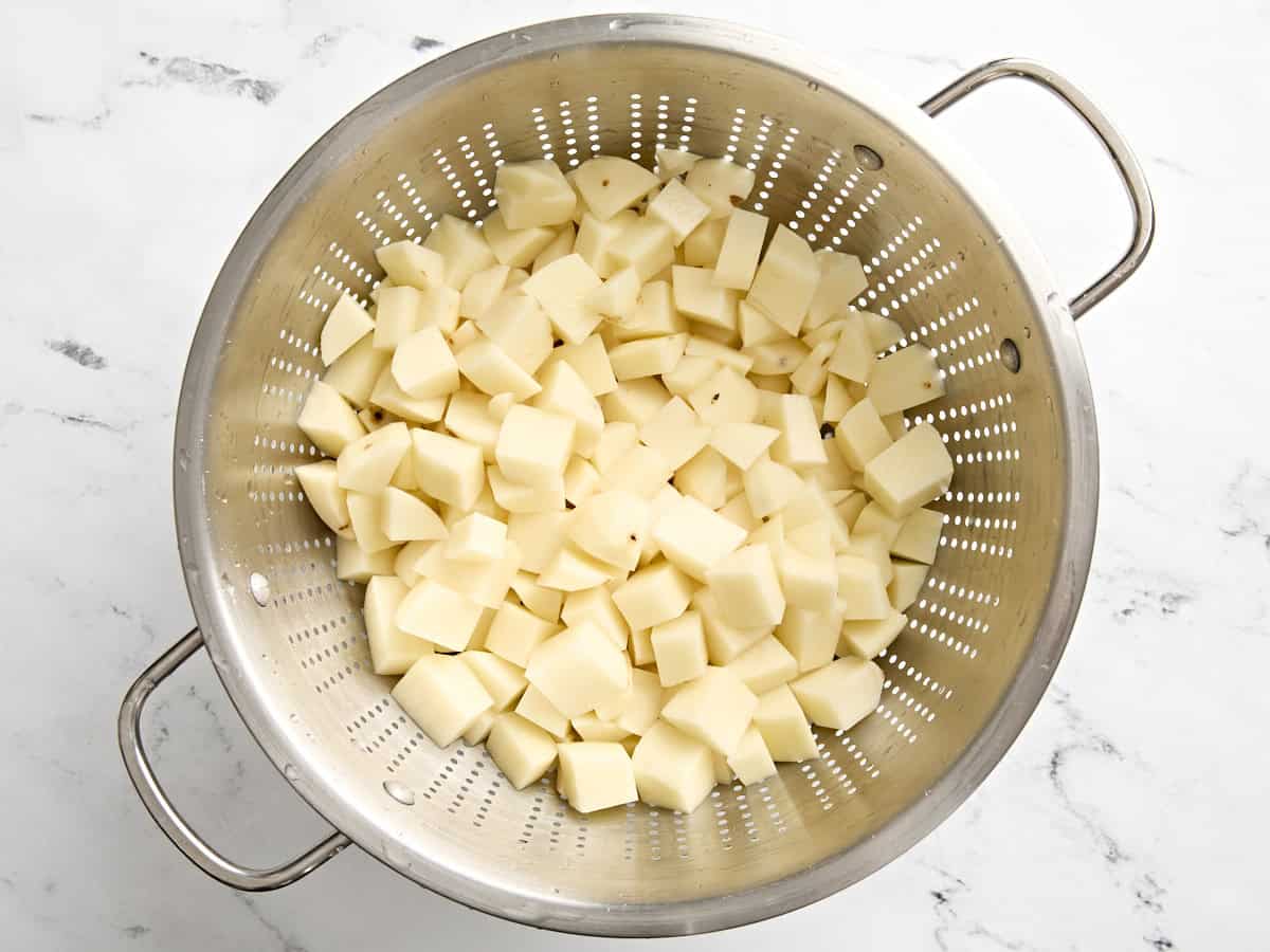 Diced potatoes in a colander.