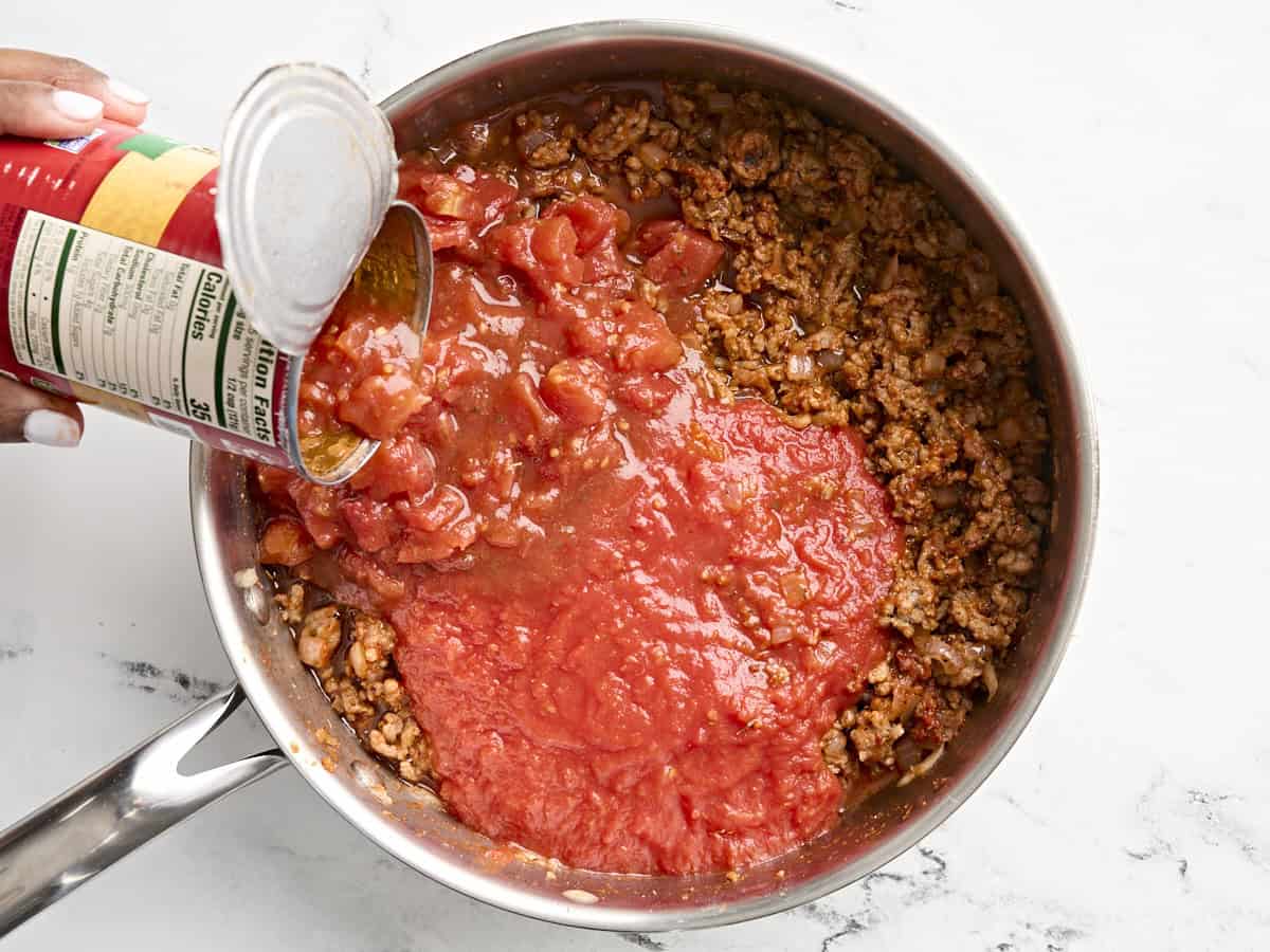 Canned tomatoes added to skillet.