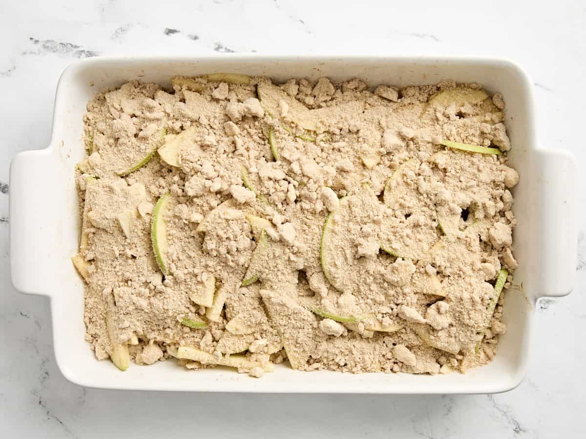 Apple crumble ingredients assembled in a rectangular baking dish.