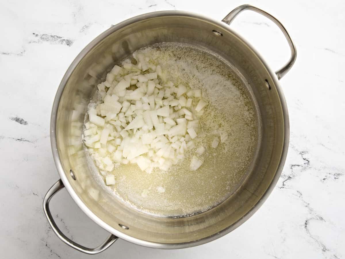 Onions and butter added to a saucepan.