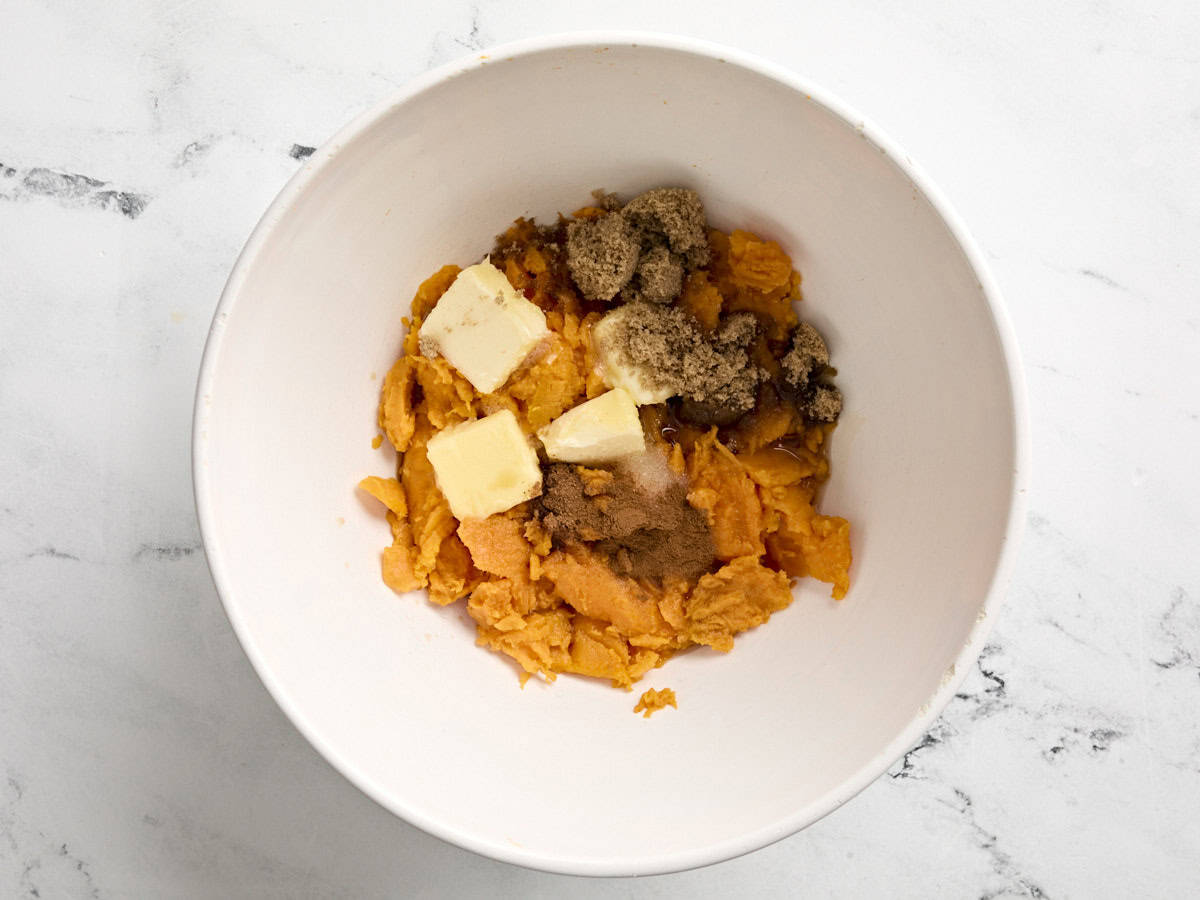 Sweet potato filling, sugar, and butter in a large bowl.