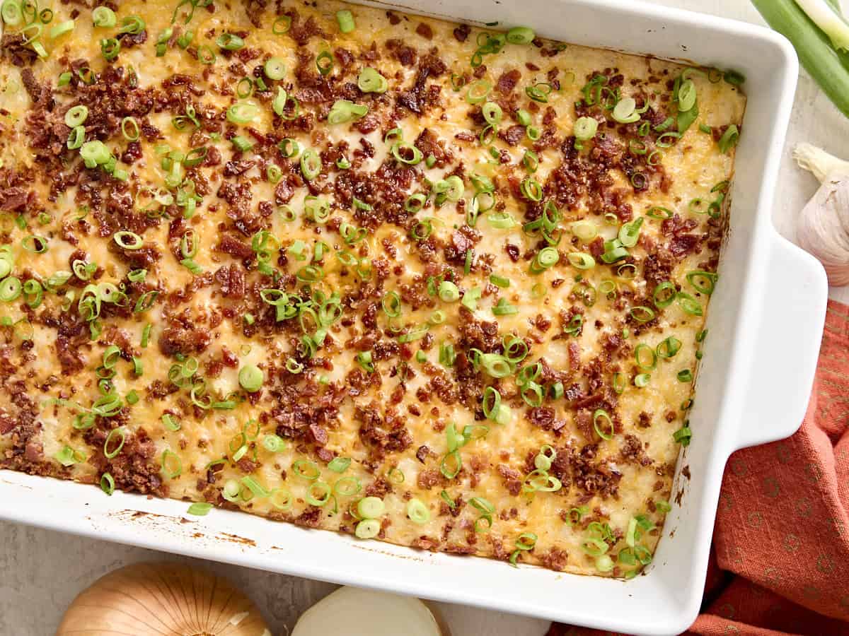 Overhead view of mashed potato casserole in a white baking dish.